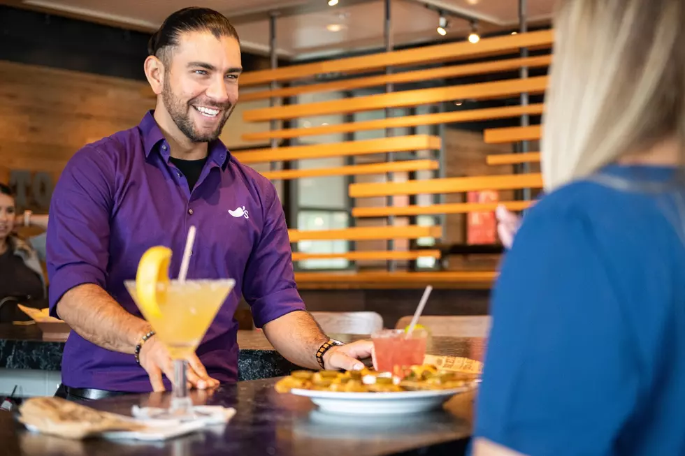 Server serving drinks and food inside a Chili's
