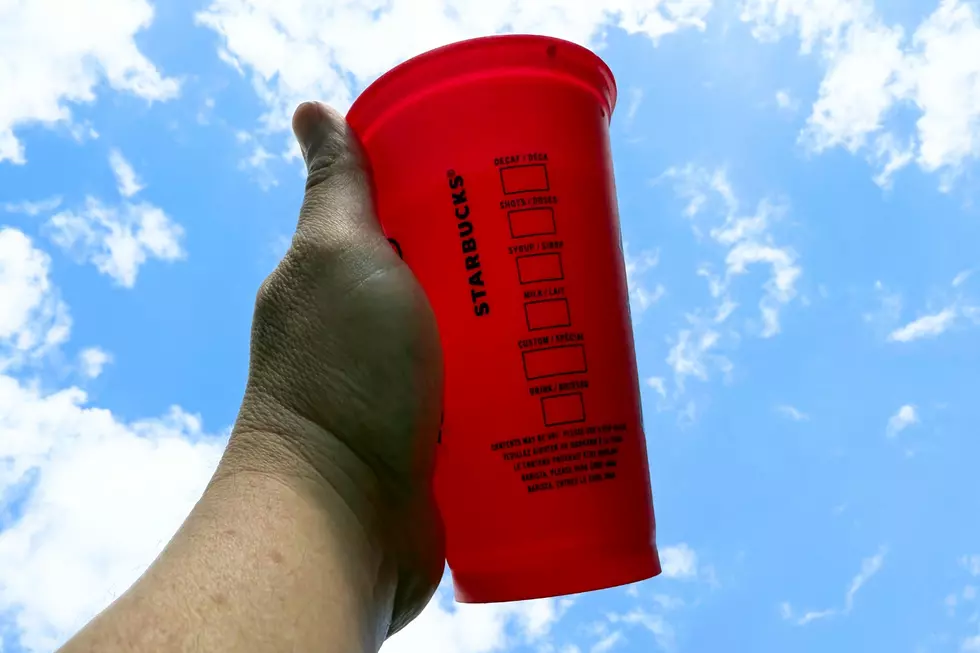 Hand holding a reusable cup from Starbucks