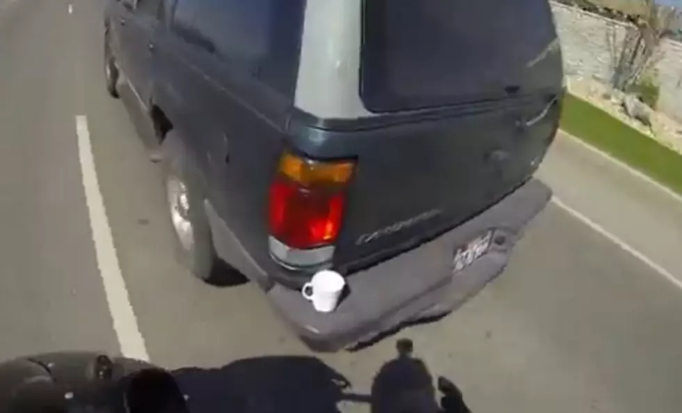 Motorcyclist Saves Coffee Mug From Bumper Of Moving SUV [Video]