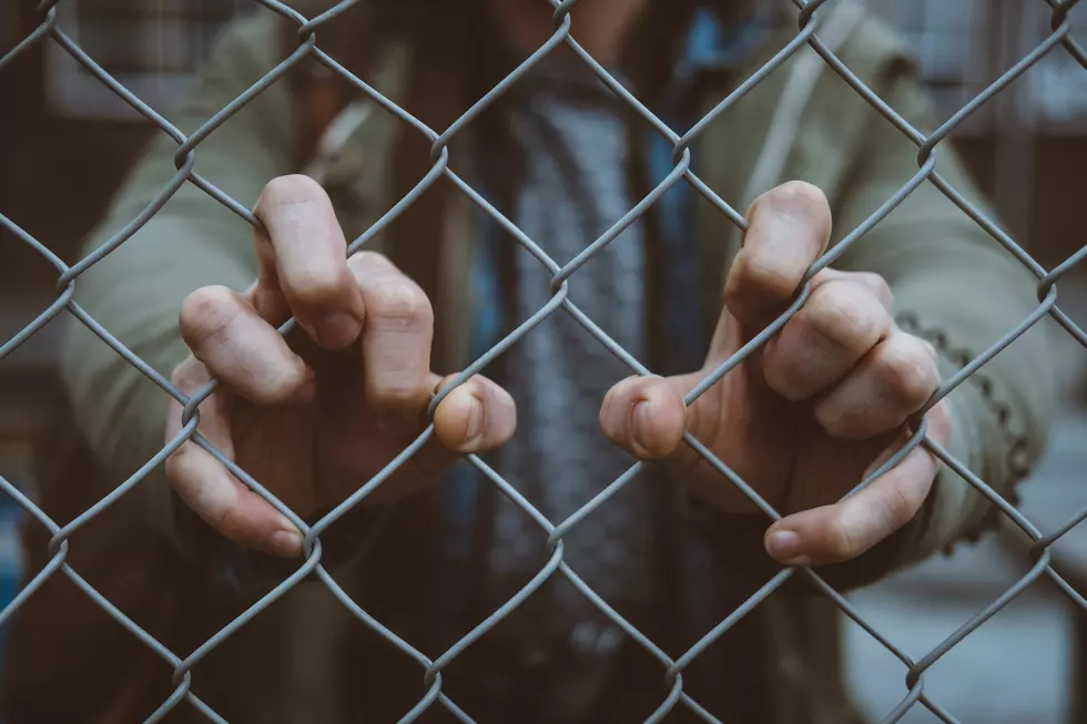 Hands on Jail Fence
