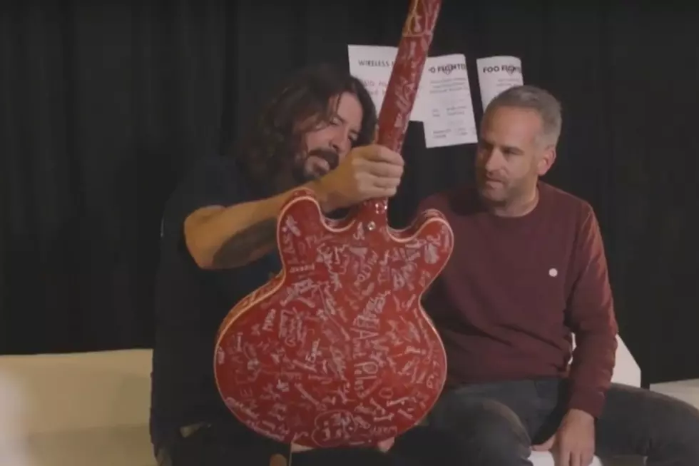 Dave Grohl Rocks Guitar Signed by Foo Fighters Fans at Rock Werchter Festival in Belgium