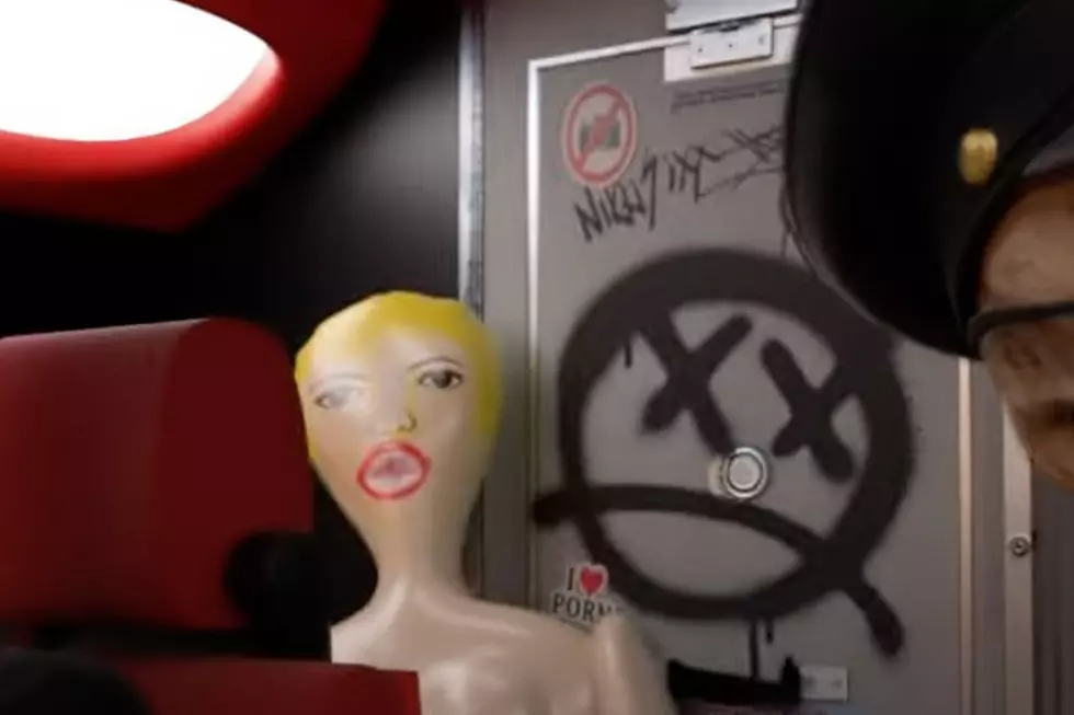 nikki sixx signature above sex doll in motley crue's 'dogs of war' video