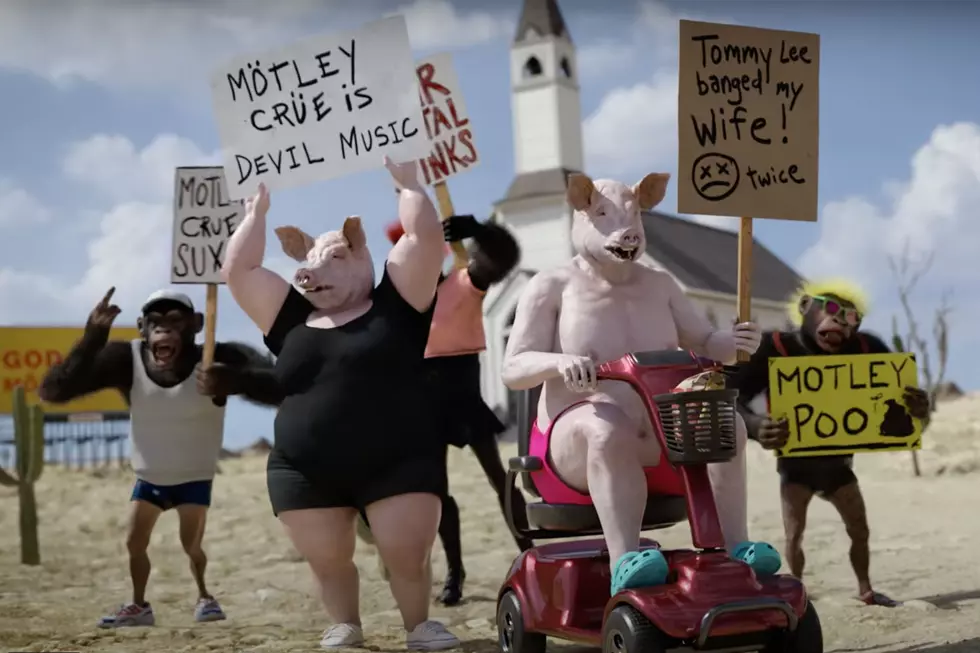 motley crue swine protestors in 'Dogs of War' video