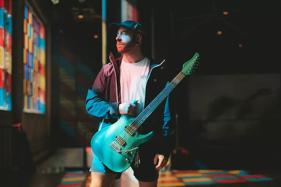 Intervals' Aaron Marshall holding green guitar