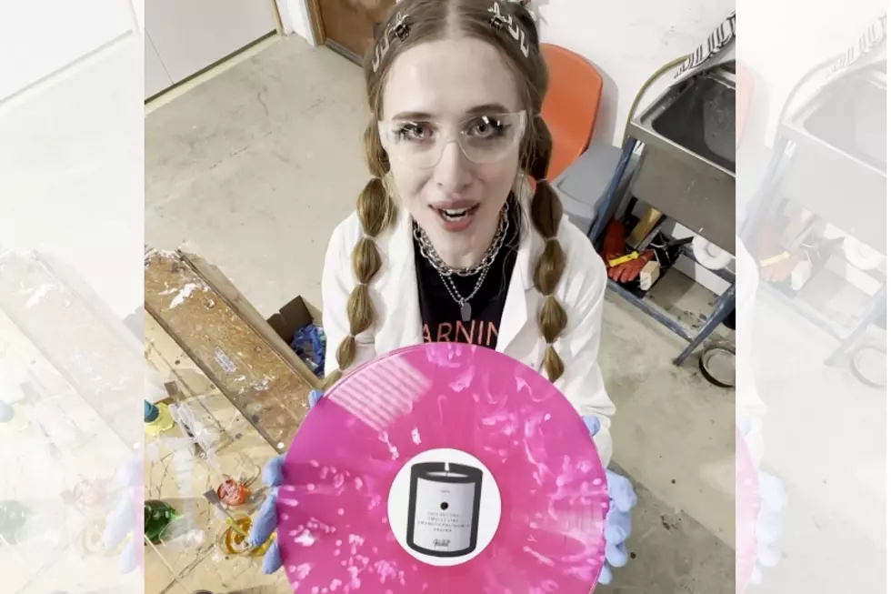 Lauren Hester of Private Function holding the band's new album
