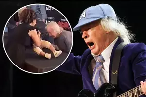 Watch AC/DC's Angus Young Sign a Fan's Baby in Toronto
