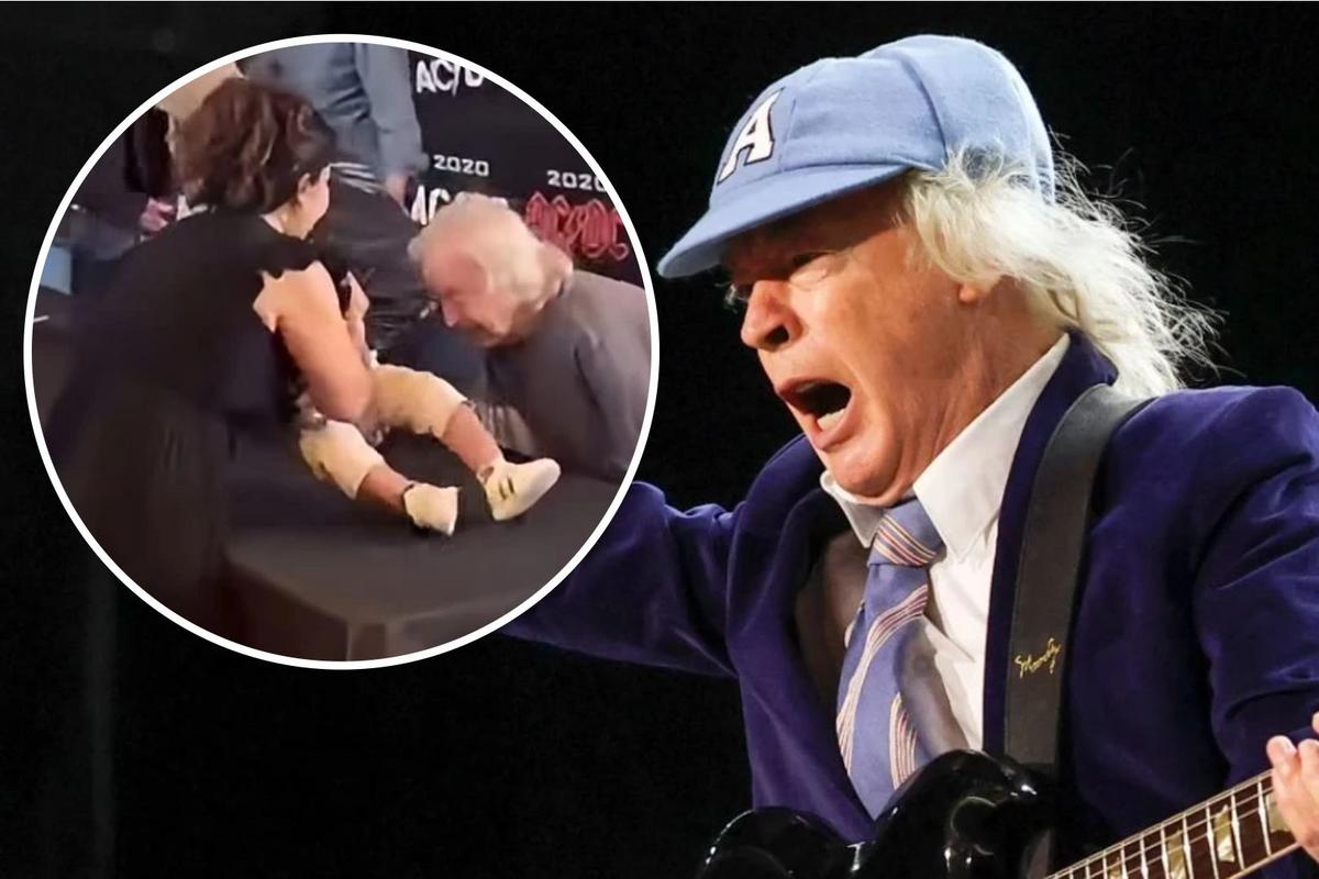 Watch AC/DC’s Angus Young Sign a Fan’s Baby in Toronto Watch AC/DC’s Angus Young Sign a Fan’s Baby in Toronto