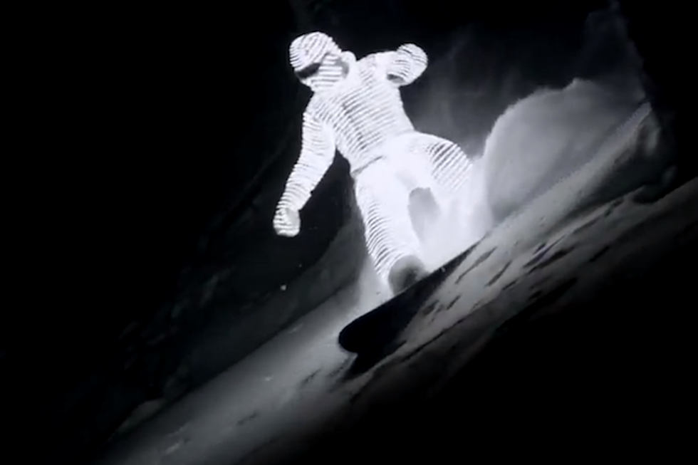 Guy in Light Suit Snowboards in the Dark