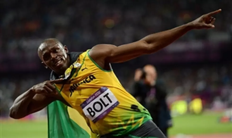 Bolt Sets Olympic Record, Wins 100M