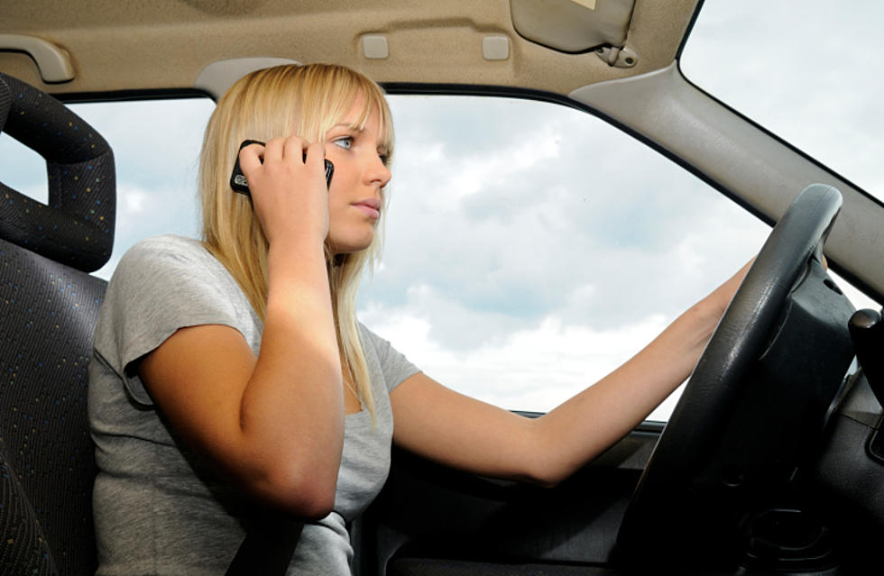Should it be illegal to hold your cell phone while driving? – Poll