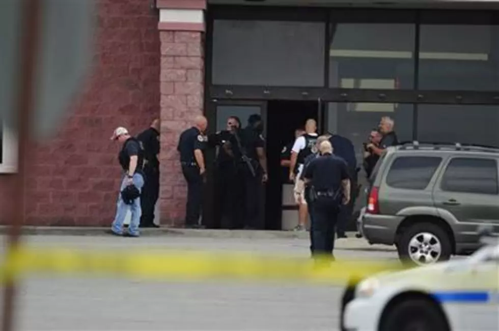 Man wielding pellet gun, ax, attacks theater; shot by police