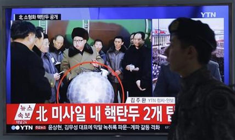 Kim Jong Un poses beside possible nuclear warhead mock-up