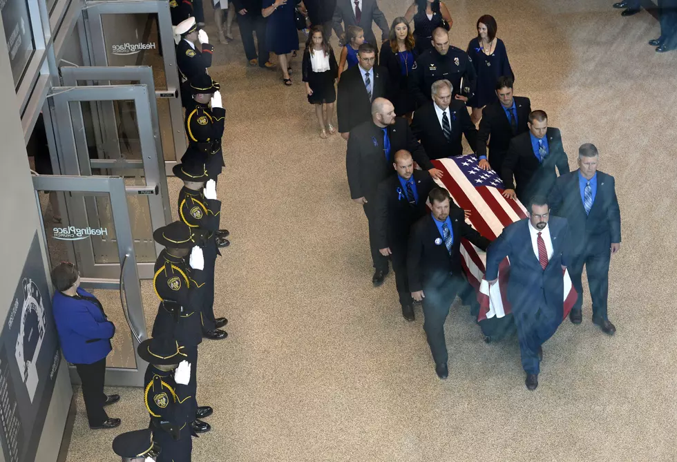 At slain officer&#8217;s funeral, calls for respect and unity