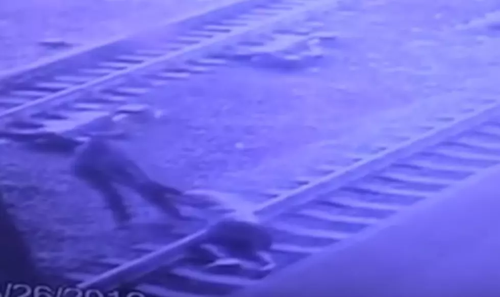 Hero cop: Watch him pull man off tracks with a second to spare