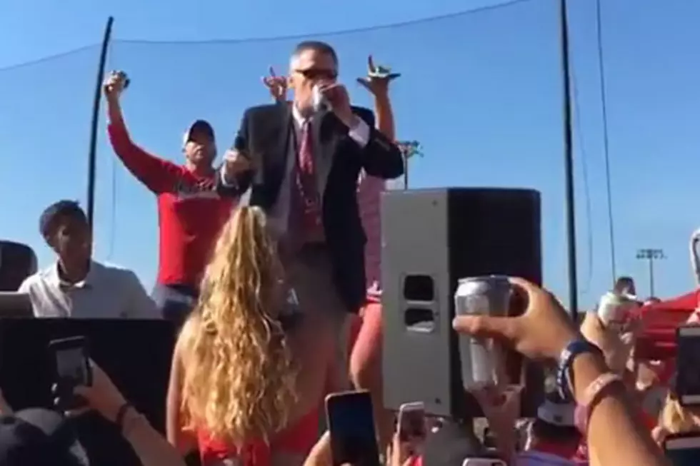 As Rutgers tailgate gets rowdy, AD Hobbs chugs beer on stage