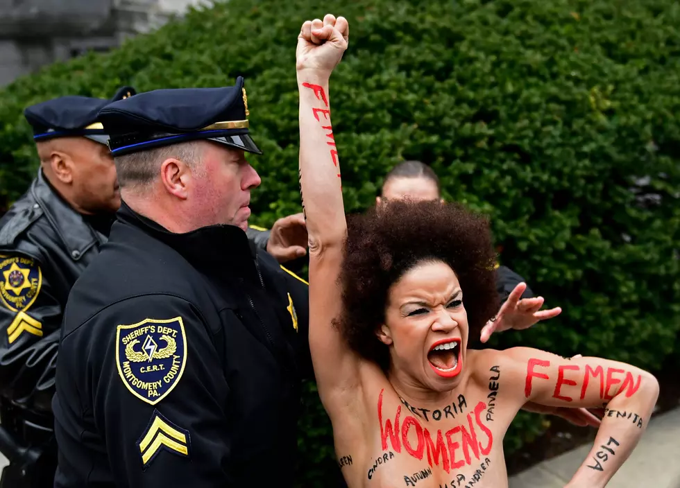 Topless NJ woman, with 50 accusers&#8217; names on body, confronts Cosby
