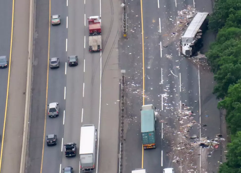 Truck overturns on Turnpike, spills load of garbage