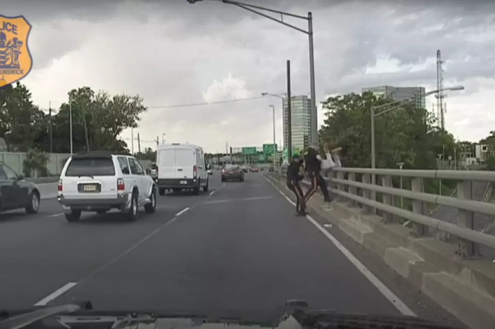 Cops pull despondent man over highway overpass railing