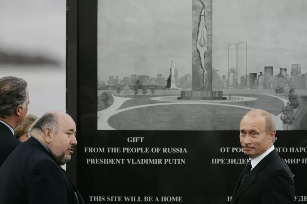 Russian President Vladimir Putin, right, stands with then-Bayonne mayor Joseph Doria in front of a memorial to victims of world terrorism during a ceremonial ground breaking for the teardrop monument 9/15/05