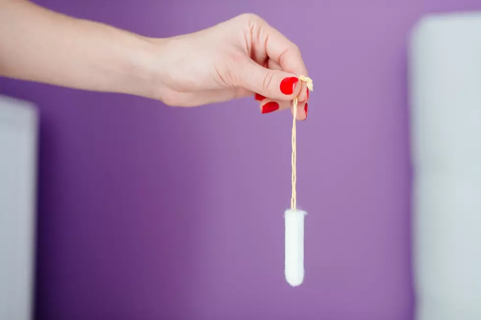 Close up on woman holding white cotton tampon in hand. Woman period