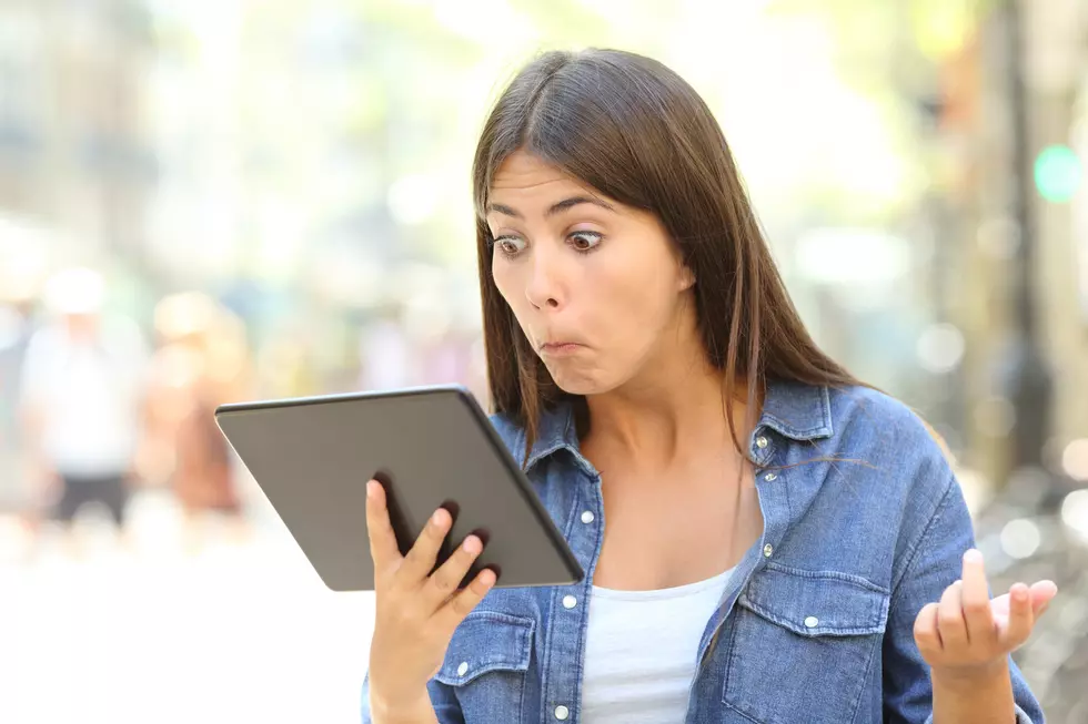 Confused girl with a tablet outdoors