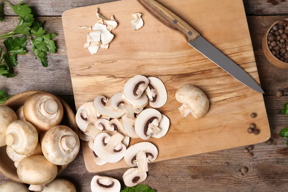 Flat lay composition with fresh champignon mushrooms on wooden table
