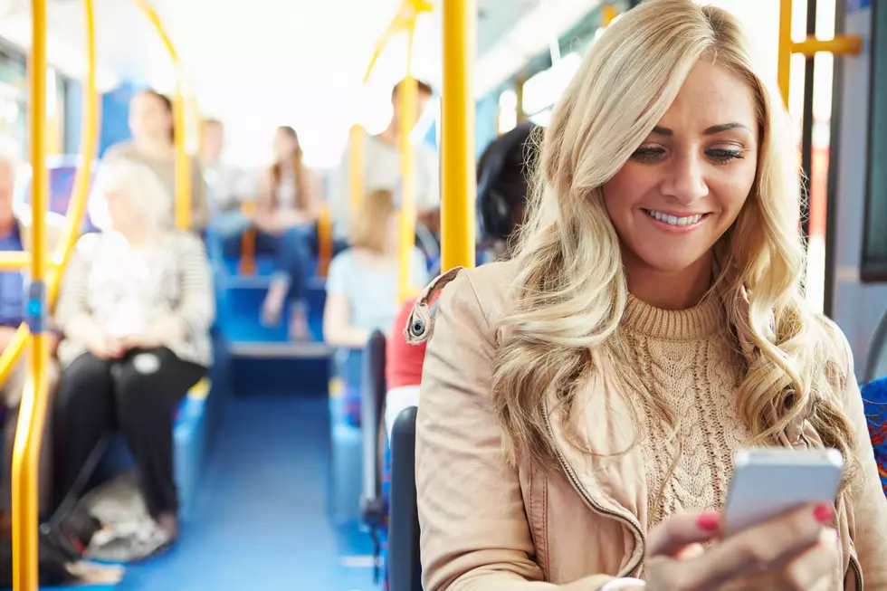 Happy Smiling Woman Reading Text Message On Bus