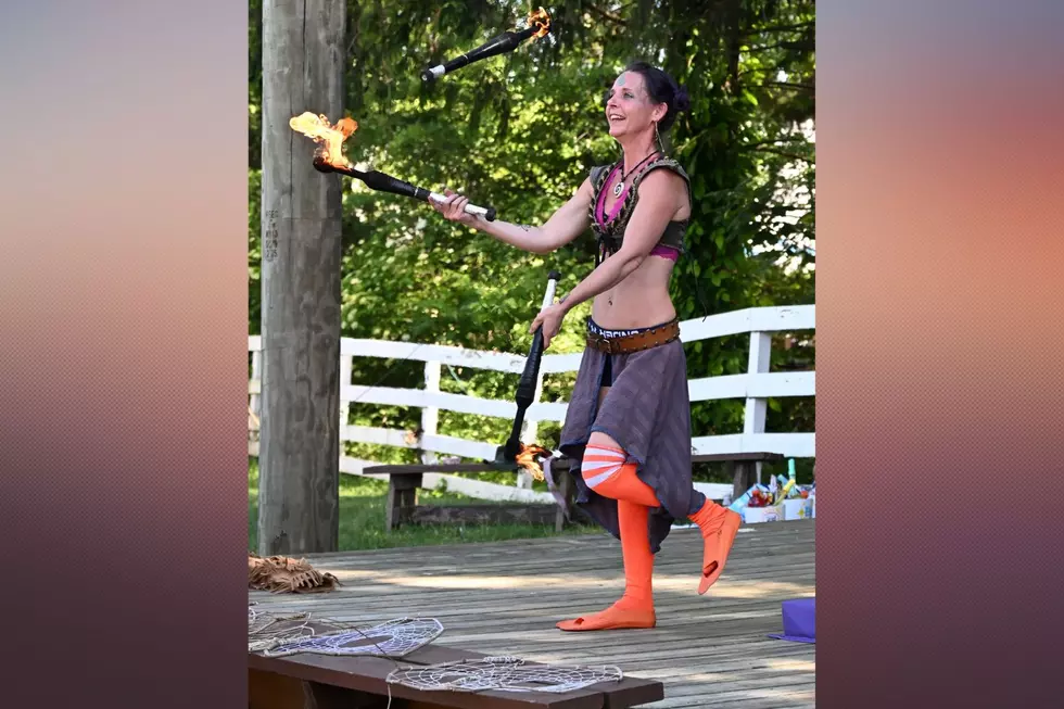 “Shelli Buttons, aerialist, juggling fire,” Photo credit- Richard Jones