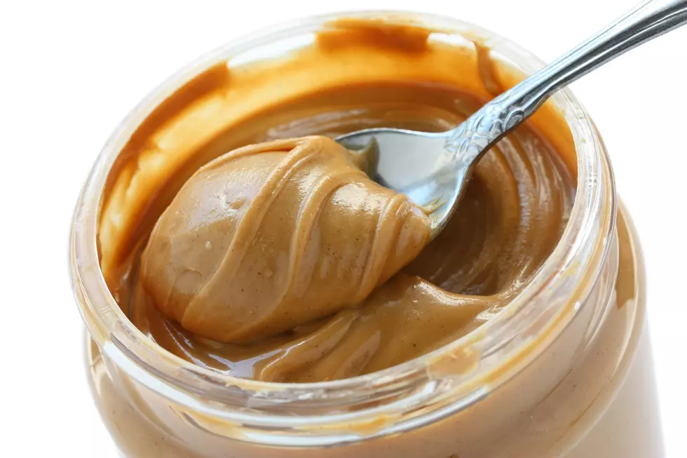 open jar of peanut butter with spoon