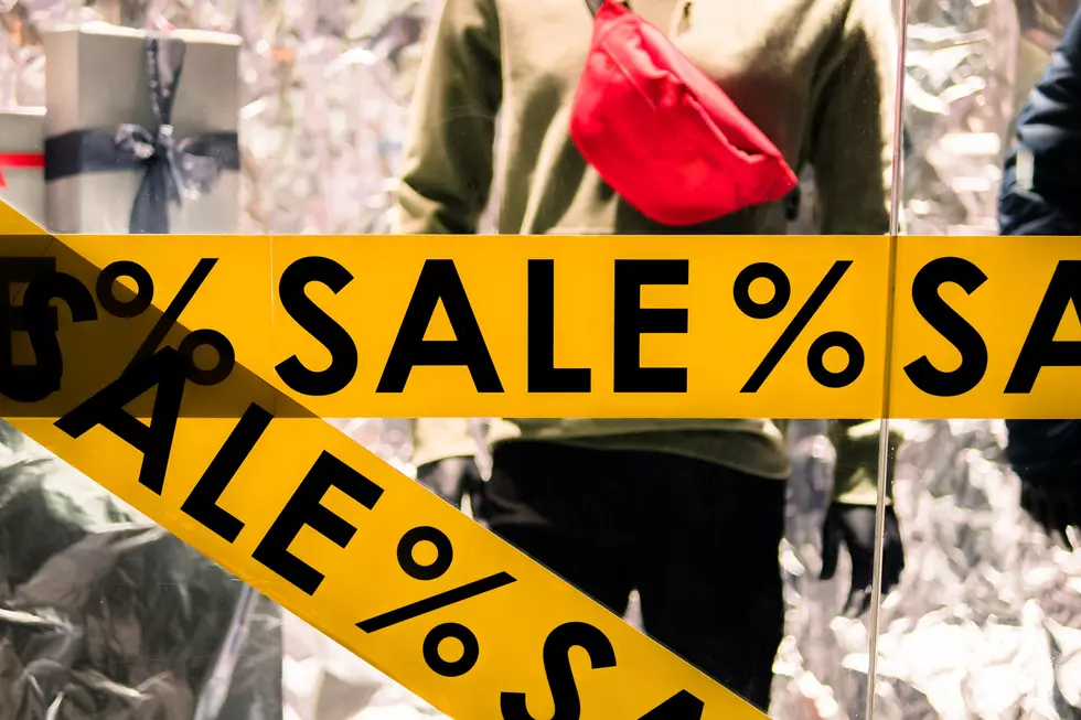 Window display with text SALE in a shop. Discount offer at the clothing store