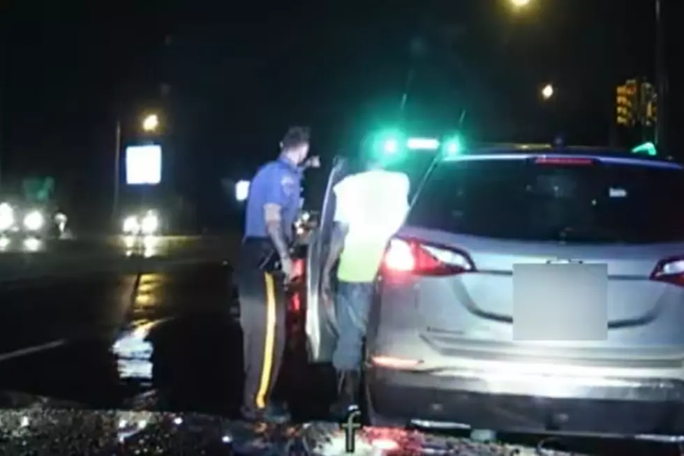 Robbinsville cop Connor Boyle helps the driver of a disabled vehicle. (Robbinsville police via Facebook)