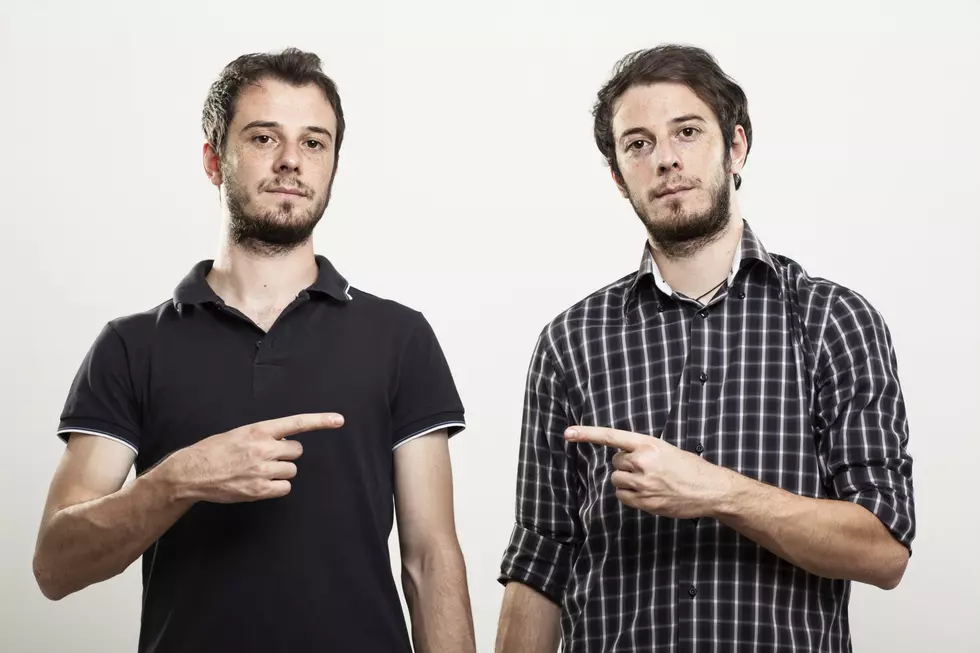 Twins Pointing Each Other