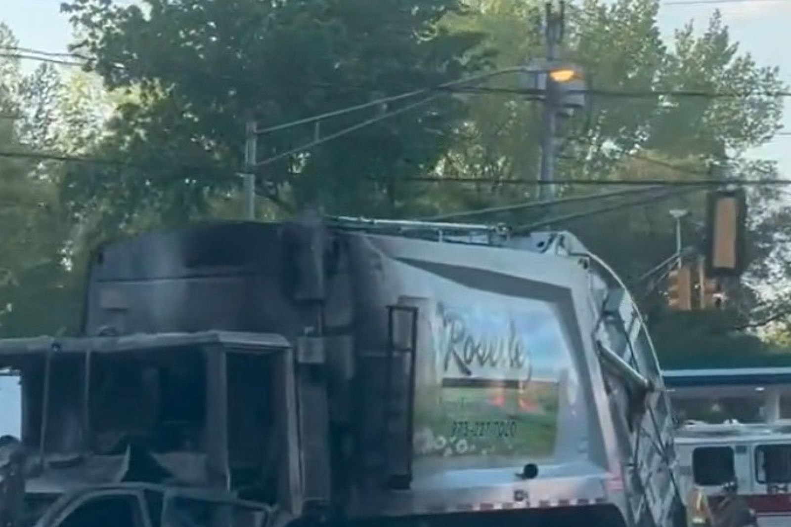 Driver charged in fatal garbage truck crash was on phone — cops