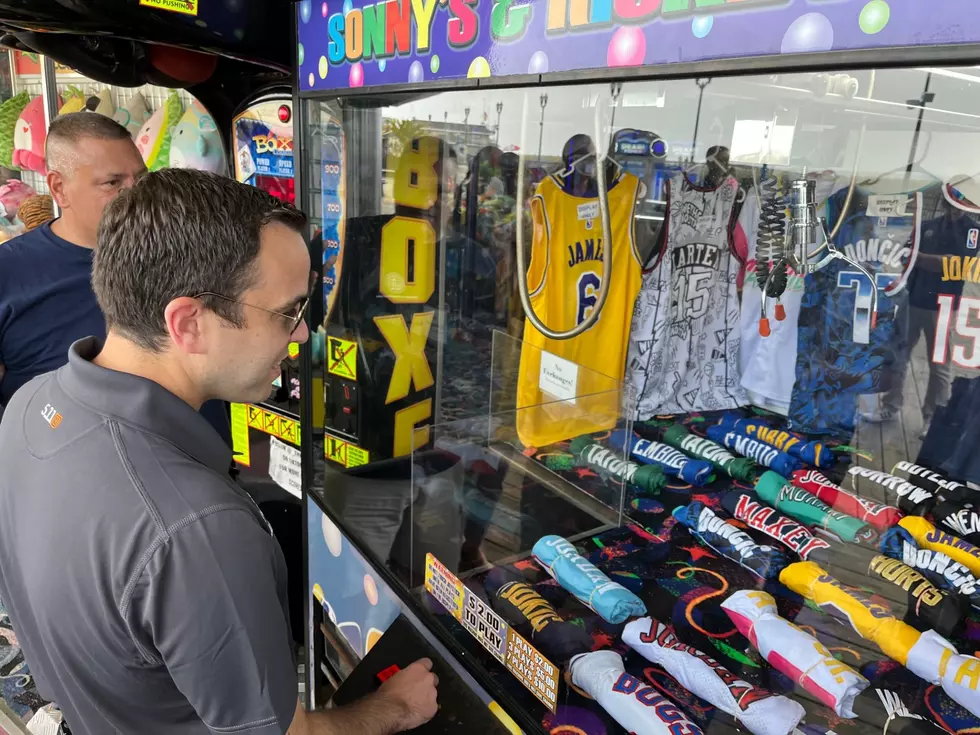 Attorney General Matthew Platkin tries his luck at a crane game along the boardwalk in Seaside Heights (Dino Flammia, Townsquare Media NJ)
