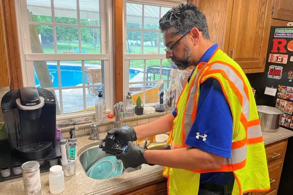 Vishal Modi, Senior Water Quality and Environmental Compliance Specialist for New Jersey American Water, taking a water quality sample at a customer’s home in Bridgewater.