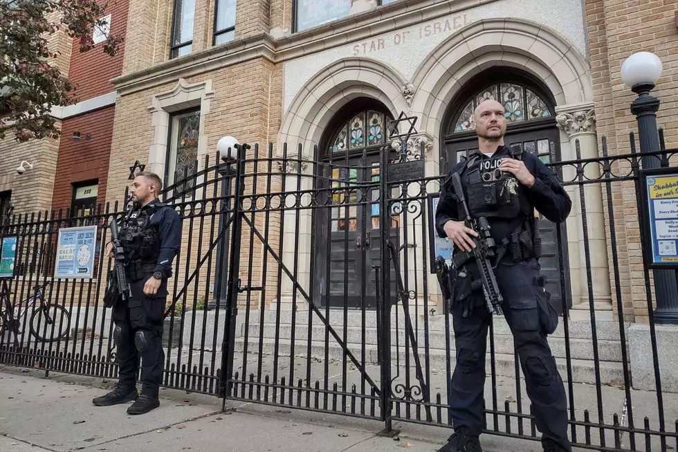Hoboken Police officers stand watch outside the United Synagogue of Hoboken