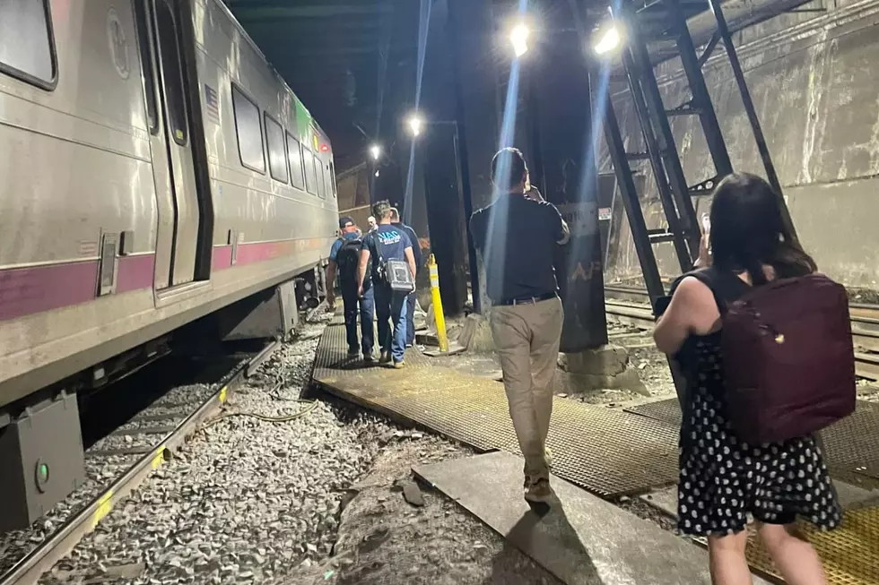 Passengers walk to their train at New York Penn Station