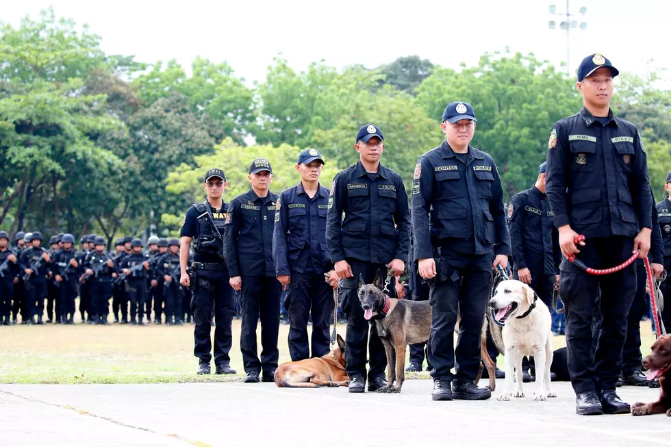 Philippine National Police K-9 unit, stand at attention during a send-off ceremony May 7, 2019. (AP Photo/Bullit Marquez)