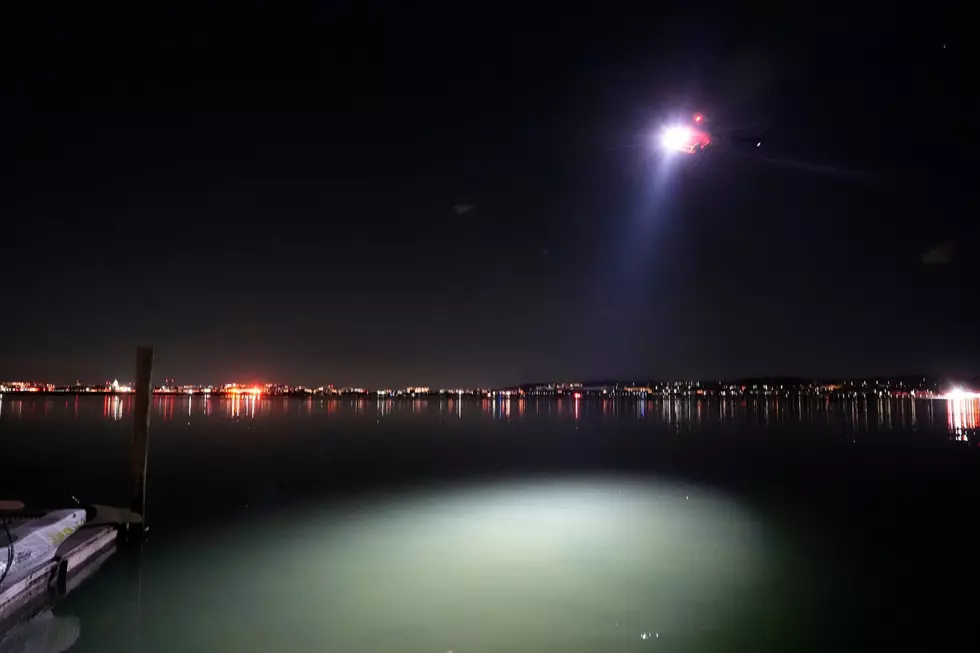 A helicopter uses a spotlight on the Potomac River near Ronald Reagan Washington National Airport 1/30/25