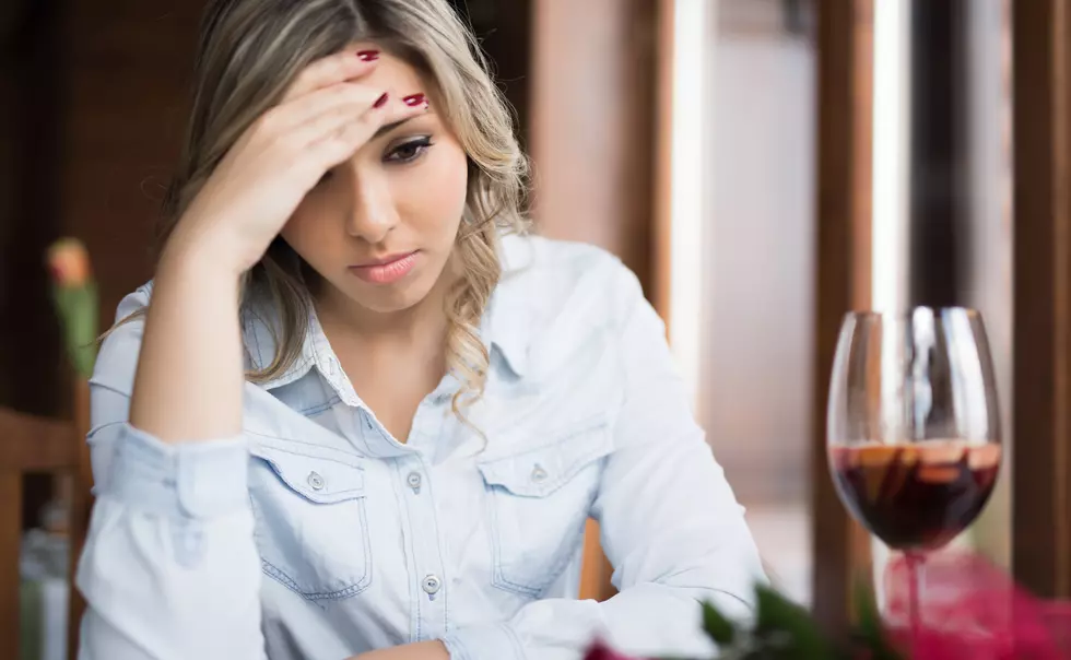 Young woman deep thinking after she had some drink