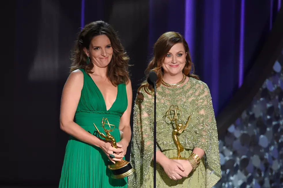 Tina Fey, left, and Amy Poehler, holding their Creative Arts Emmy awards (Photo by Chris Pizzello/Invision/AP)