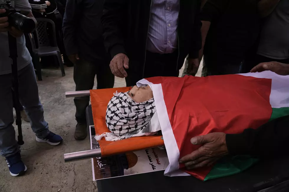 Mourners encircle Amer Mohammed Rabee during his funeral in the West Bank (AP Photo/Mahmoud Illean)