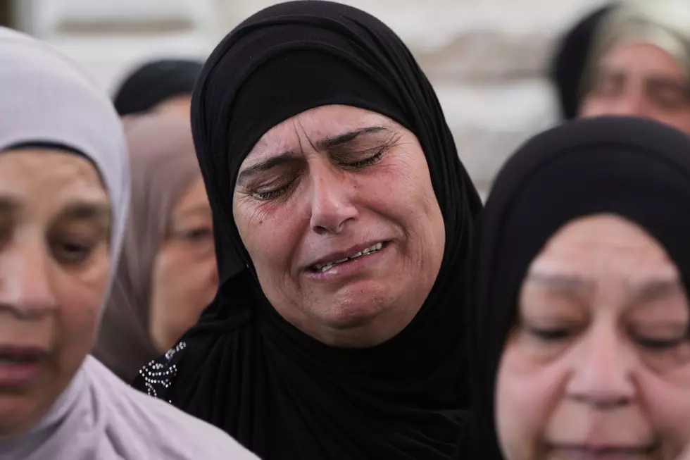 A woman weeps at the funeral of Amer Mohammed Rabie, a 14 year-old Palestinian-American shot by Israeli forces, in the West Bank town of Turmus Ayya, Monday, April 7, 2025. (AP Photo/Mahmoud Illean)