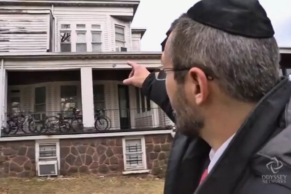 A rabbi points to where a Molotov cocktail was thrown through the window of a Rutherford synagogue.