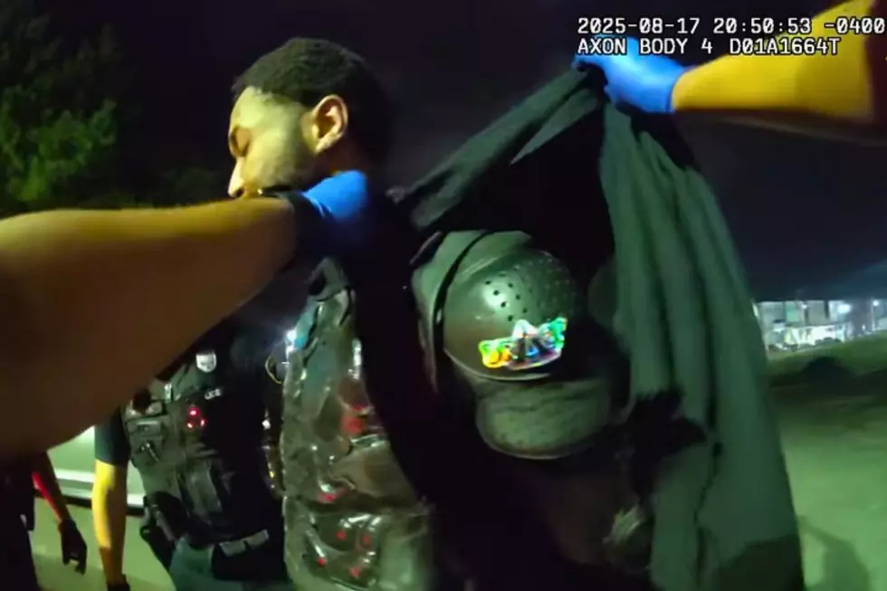 Curtis Bordley, the AC Batman, takes off his costume for police officers (Jersey Shore Scanner News via YouTube)