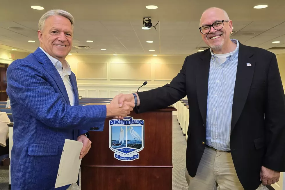 Joe Clark (right) accepts congratulations from Stone Harbor Mayor Tim Carney during Clark's swearing-in ceremony at the borough's July 1 council meeting (Stone Harbor)