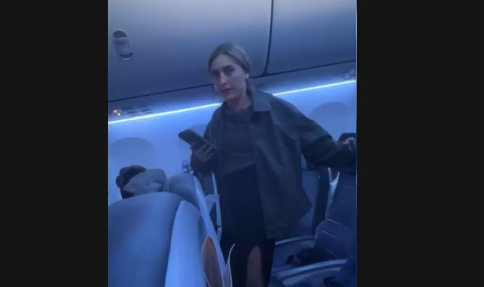 The moment and irate passenger on a flight from Newark realizes she is being recorded. (screengrab/@haleyrose via TikTok)