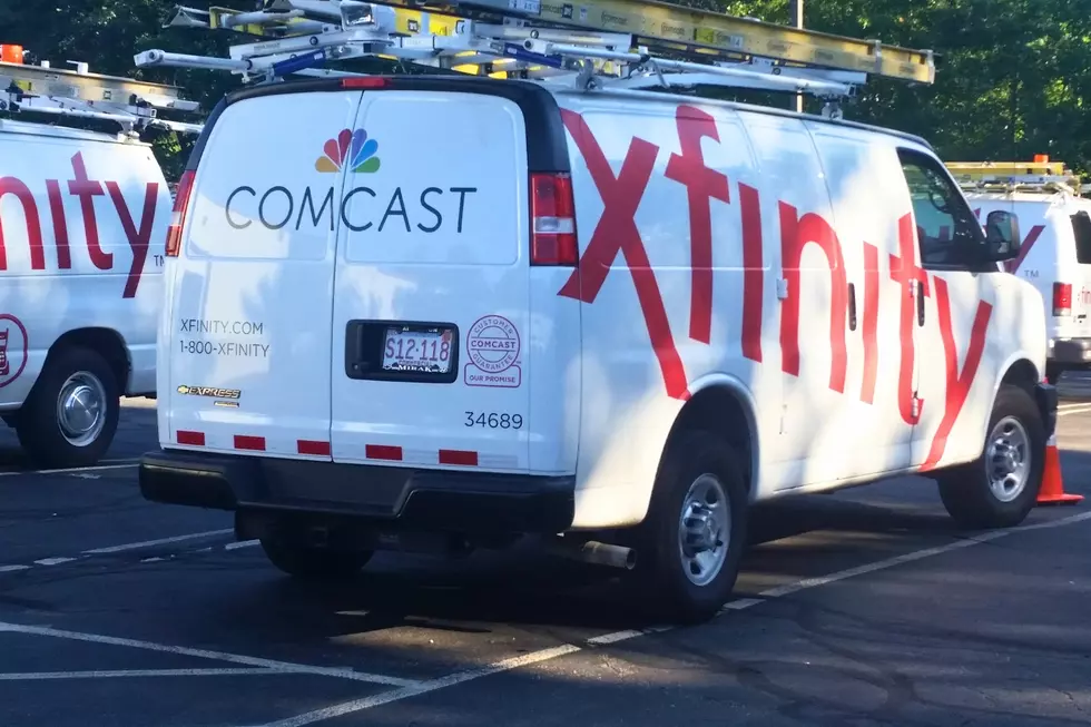 In this Sept. 17, 2015, file photo, Comcast trucks are parked in a lot in the company's Westford, Mass. operations center. AP Photo/Tali Arbel, File)