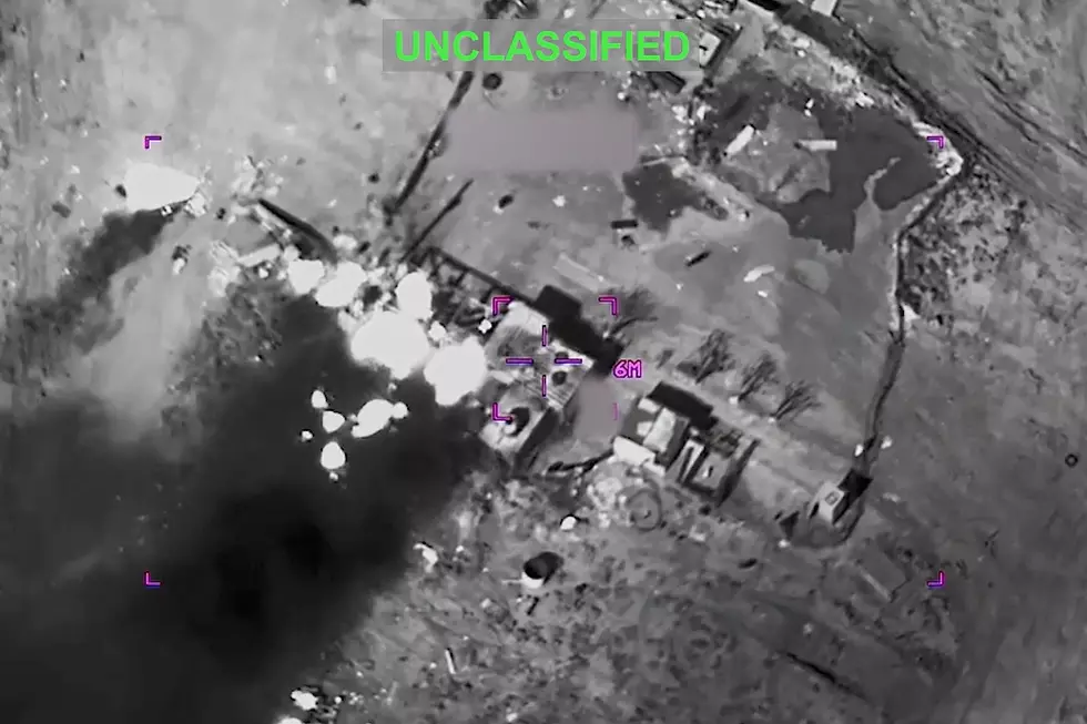 This partially redacted image from video provided by U.S. Central Command shows a complex of structures in Iran being struck by missiles fired by U.S. forces on Sunday, March 1, 2026. (U.S. Central Command via AP)