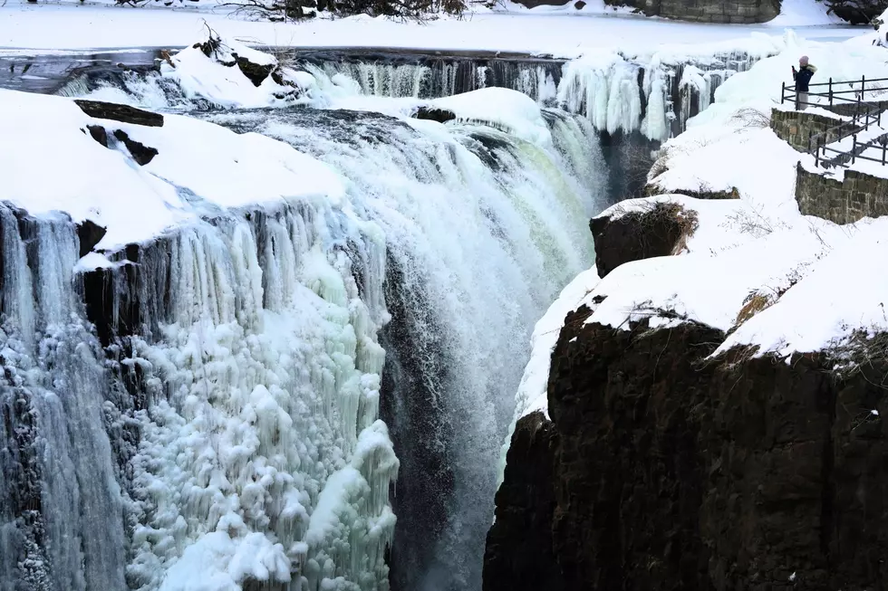 A visitor looks over the partial frozen Great Falls in Paterson, NJ on Jan. 28, 2026. (AP Photo/Seth Wenig)